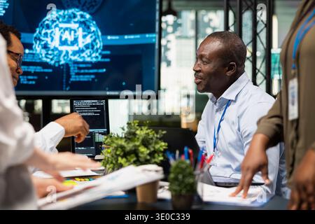 AI startup engineers brainstorming to create neural network deep learning models. System administrators collaborate on artificial intelligence project to develop scalable solutions for businesses Stock Photo