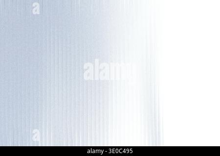 A textured metallic surface with a fine grain and subtle vertical lines, fading into a bright white background Stock Photo