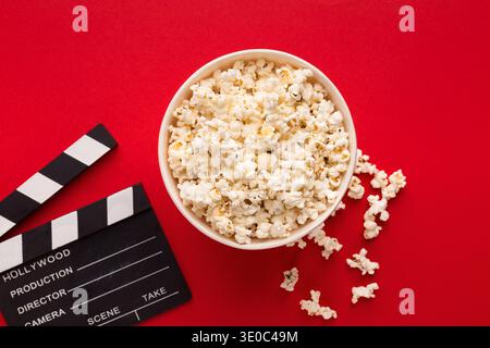 Clapperboard popcorn on red background Stock Photo