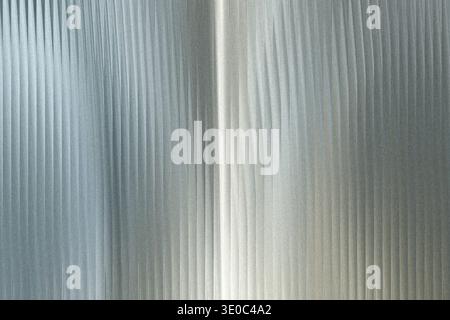 A closeup view of corrugated galvanized metal sheeting, showcasing its textured surface and vertical ridges with a subtle sheen Stock Photo