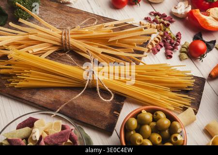 Pasta and cooking ingredients on white wood Stock Photo