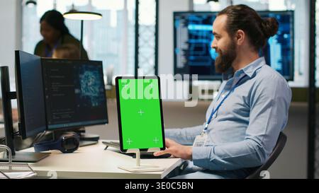 Startup technician using isolated screen tablet, developing artificial intelligence models for business analytics. IT expert using chroma key device, running simulations for AI forecasting, camera A Stock Photo