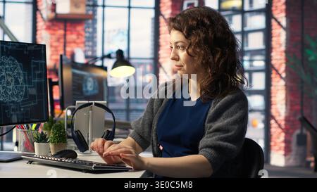 IT expert writing code and debugging on artificial intelligence neural networks computerized brain model. Woman tech support doing checkup on AI systems, cloud computing. Camera B. Stock Photo