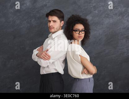 Confident business couple on gray background Stock Photo