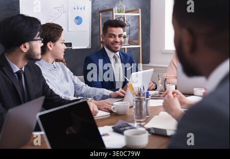 Multiracial business people discussing project at meeting Stock Photo