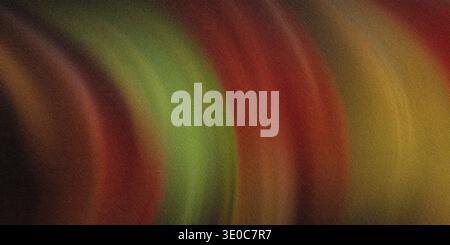 An image featuring a blurred abstract background with a blend of warm autumnal colors. The colors swirl and blend together creating a smooth gradient Stock Photo