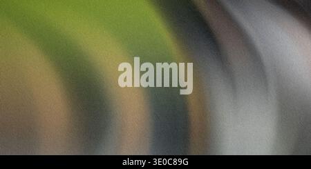 This image showcases a blurred abstract background featuring a blend of muted green, gray, and brown hues creating a smooth, flowing effect. Stock Photo