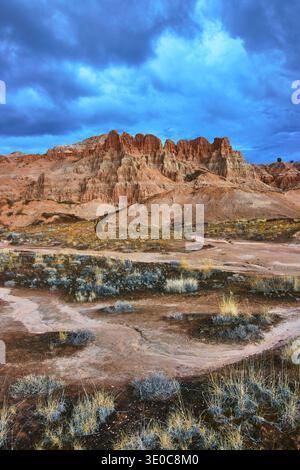 Cathedral Gorge State Park Dramatic Eroded Cliffs Desert Vegetation under Stormy Sky Stock Photo