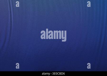 A close-up shot reveals a textured blue background, exhibiting a subtle gradient and slight wrinkles, creating a visually appealing abstract image. Stock Photo