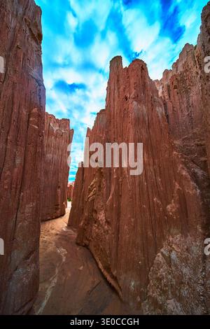 Cathedral Gorge Slot Canyon Dramatic Red Rock Formations Under Vibrant Cloudy Sky Stock Photo