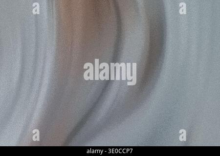 An image showcasing the texture and subtle color shifts of a softly draped light-grey fabric. The focus is on the abstract patterns created by the fol Stock Photo
