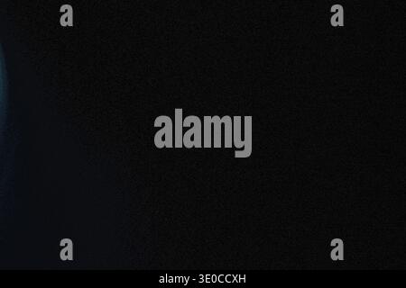 An image featuring a predominantly dark background with a subtle, blurred light leak emanating from the left side, creating a gradient effect towards Stock Photo