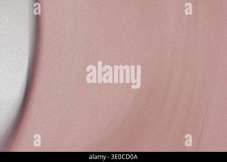 The image presents a detailed close-up of a smooth, pale pink fabric. The texture appears subtly uneven with slight variations in the shade of pink an Stock Photo