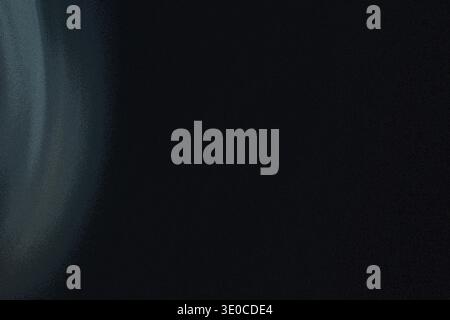 An image featuring a dark background with a soft, light blue smoky or hazy effect concentrated on the left side, gradually fading into the deep black Stock Photo