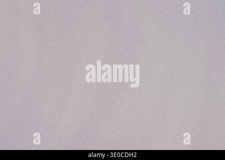 A softly blurred image showcasing a pale lilac and white textured background. The texture is subtle and the colors are muted, creating a calming and u Stock Photo