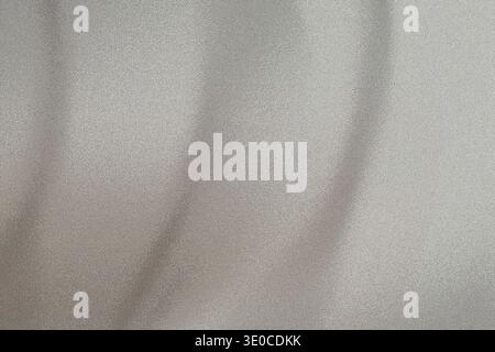 A softly blurred image showcasing the texture of light gray fabric. Vertical creases and folds are subtly visible, creating a smooth, understated back Stock Photo