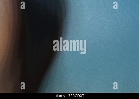 The image shows a blurred close-up of a person's face, featuring dark hair on one side and a teal background on the other. The focus is intentionally Stock Photo