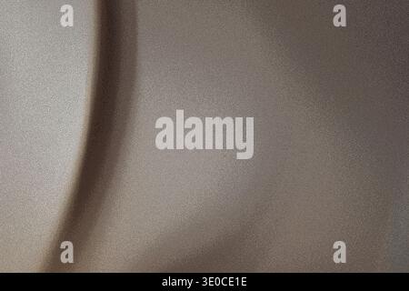 A close-up shot reveals the subtle texture and folds of a taupe-colored fabric. The image emphasizes the soft light and shadow play across the materia Stock Photo