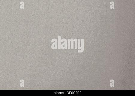 The image shows a detailed close-up of a light gray or beige surface with a slightly grainy texture. The color is uniform, and the texture is subtle b Stock Photo