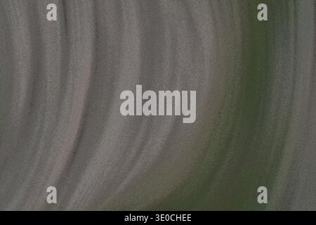 The image shows a detailed close-up view of a fabric with a draped texture. The colors are predominantly light grey transitioning to a muted green, cr Stock Photo