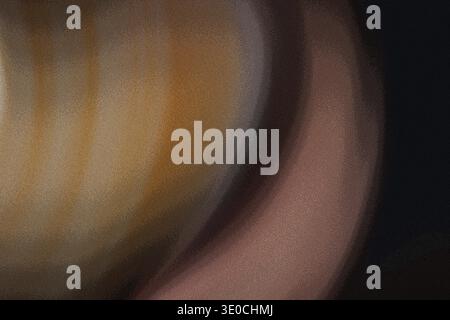 The image shows an out-of-focus close-up of a rounded, golden-brown object. The surface appears smooth and possibly slightly reflective. The backgroun Stock Photo