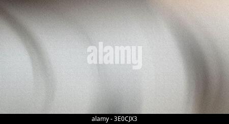 A softly blurred image featuring a grayscale gradient, creating an abstract and subtly textured background. Stock Photo