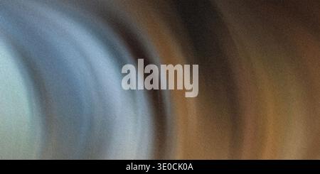 An abstract image featuring a blurred blend of cool blues transitioning into warm browns, creating a swirling, dynamic effect. Stock Photo