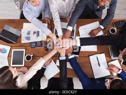 United hands of business team on workspace background Stock Photo