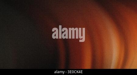 An abstract image featuring a blurred gradient of dark brown transitioning into warm orange and light brown tones. The effect creates a smooth, flowin Stock Photo