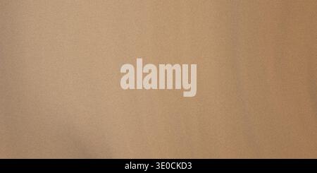 A simple image featuring a light brown solid color background. The texture is smooth and subtly shaded. Stock Photo