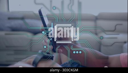 Holding phone horizontally, male hands showing microchip overlay on couch, in pink shirt and watch Stock Photo