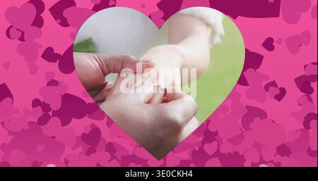 Placing man sliding engagement ring on woman finger with white lace, heart cutout, pink hearts Stock Photo