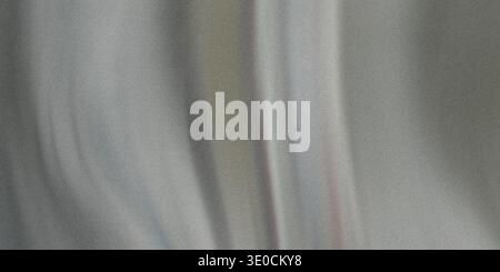 A blurry image showing the texture of light grey fabric, possibly silk or a similar material, draped in soft folds. Stock Photo