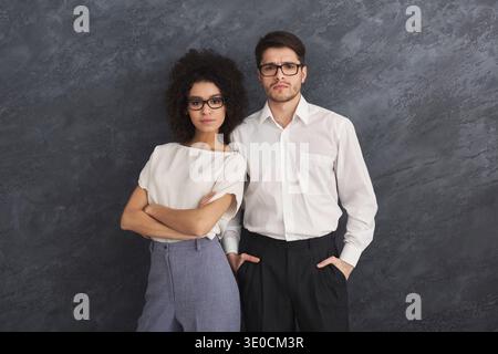 Confident business couple on gray background Stock Photo