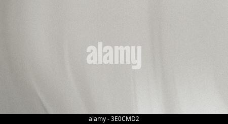 A softly blurred image showcasing a light grey fabric texture with subtle folds and variations in tone. The background is simple and minimalist. Stock Photo