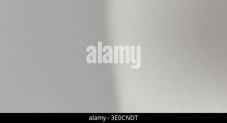 A photograph depicting a subtle gradient of light across a smooth, gray surface. The image is primarily light gray with a barely perceptible shift in Stock Photo