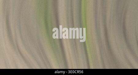 An image featuring blurred vertical streaks of beige and subtle green hues, creating an abstract texture resembling flowing fabric or light. Stock Photo