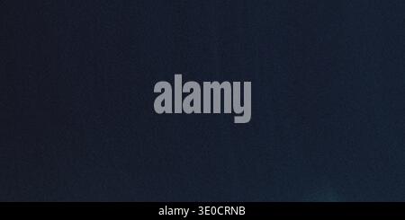 A simple image featuring a solid dark blue background. The color is uniform with subtle variations in tone. Stock Photo