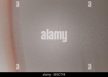The image shows an out-of-focus photograph of a wall. The wall appears to be a light beige or gray color. A thin, vertical orange line is visible on t Stock Photo