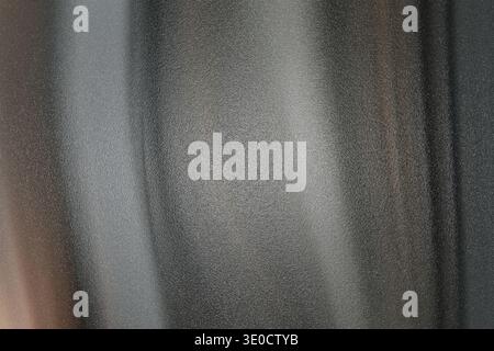An image featuring a blurred abstract background with vertical lines predominantly in shades of grey and brown. The texture appears smooth with subtle Stock Photo