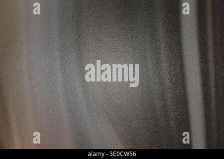 A detailed image showcasing the texture of a dark gray fabric with subtle white vertical stripes. The fabric appears soft and possibly woven. Stock Photo