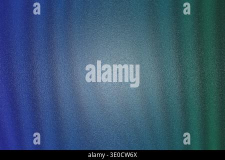 A blurred image featuring a vertical gradient transitioning from dark blue to teal and then to a muted green. The texture is slightly grainy, creating Stock Photo