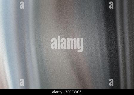 An out-of-focus photograph showcasing a blend of vertical lines and muted grey and brown color gradients. The image has a soft, abstract quality. Stock Photo