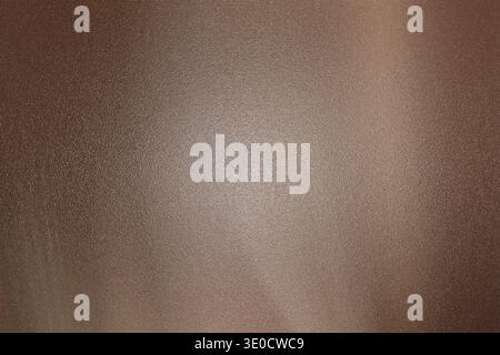 A high-resolution image showcasing a dark brown brushed metal texture with a subtle gradient effect. The background features a smooth, metallic appear Stock Photo