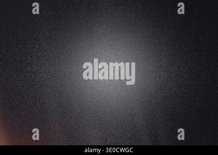 A dark gray background image features a subtle textured effect and a slightly brighter central area, creating a vignette-like effect. The texture is f Stock Photo