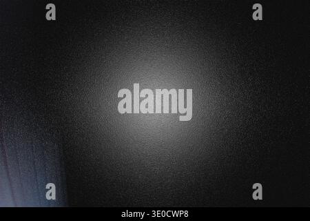 A dark gray background features a blurred, textured effect. A lighter gray gradient emanates from the center, creating a subtle spotlight effect. The Stock Photo