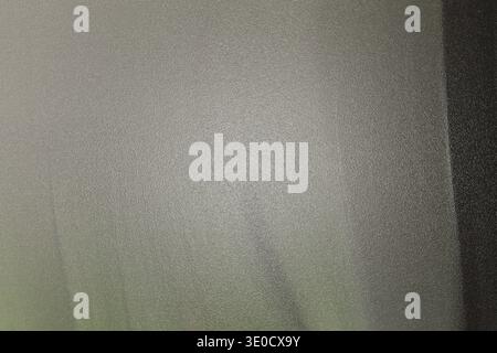 The image shows a detail of a wall with a light beige or off-white color. The texture is slightly uneven, showing subtle variations in tone and a hint Stock Photo