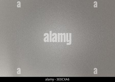 A slightly blurred image showcasing a subtle gradient of light gray tones. The texture is smooth with a hint of unevenness, creating a muted backgroun Stock Photo