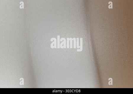 The image shows an out-of-focus view of a white or light-grey surface next to a light brown surface. The boundary between the two is clearly visible b Stock Photo