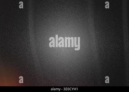 A dark gray background image features a textured surface with a slightly lighter center, creating a subtle spotlight effect. The edges are softly blur Stock Photo